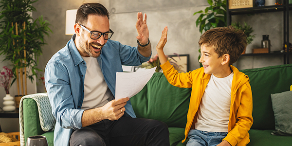 pai e filho conferindo o boletim escolar 